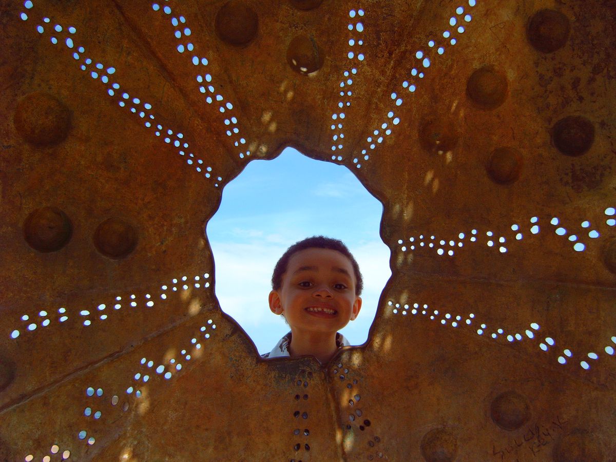 My young Nephew having fun exploring a piece of public art in Dublin, Ireland