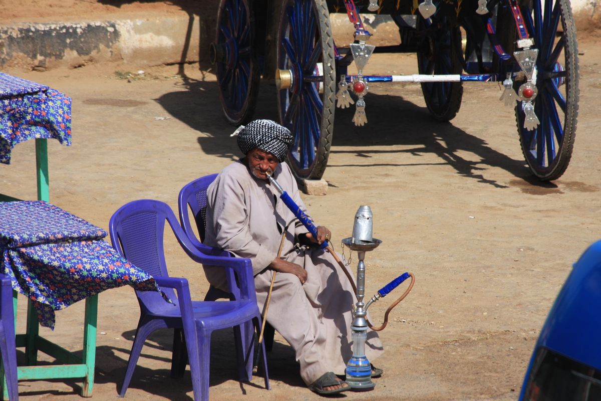 Local Egyptian relaxing with huba pipe