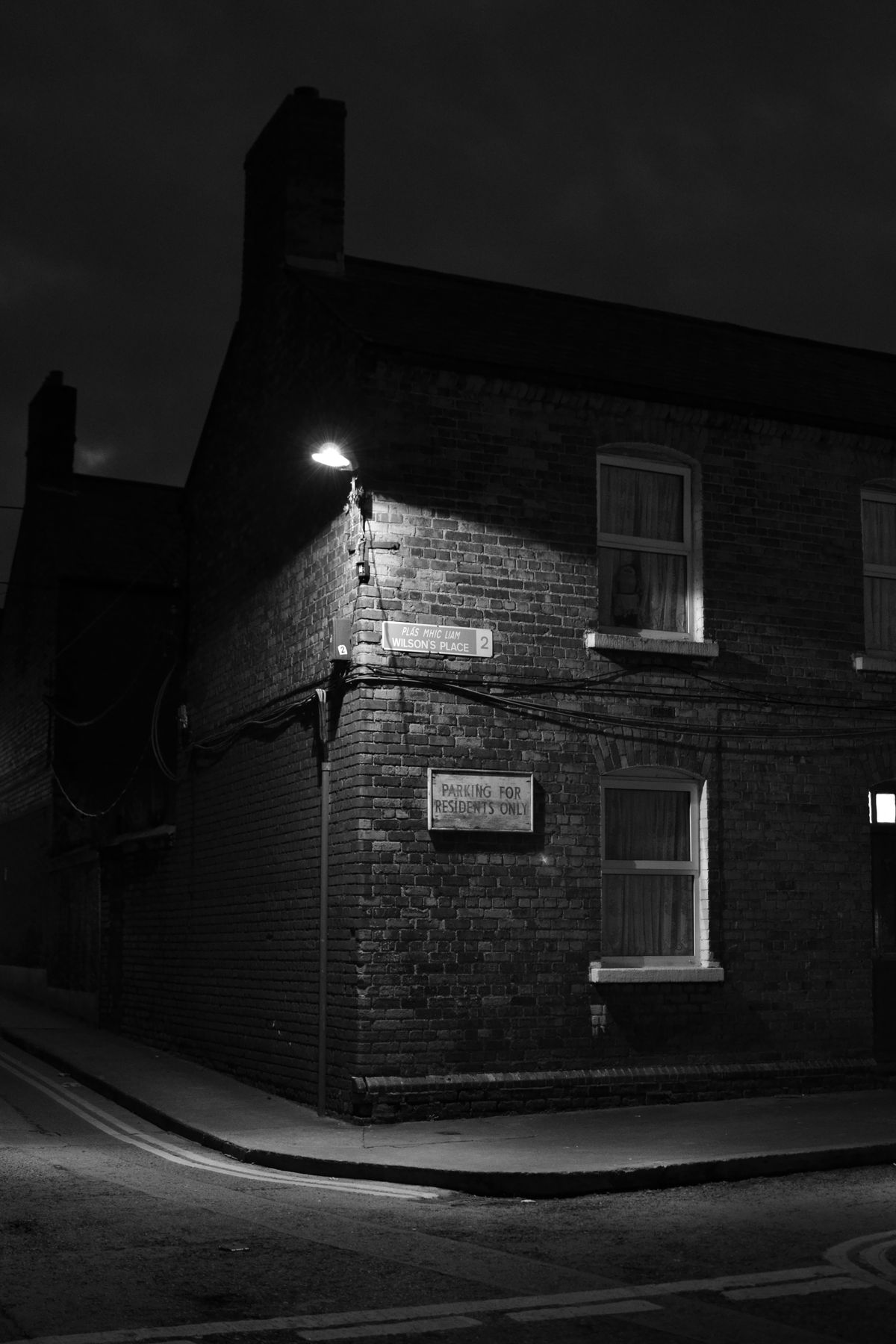 Taken shortly after dusk in Dublin this photo shows a typical inner city street  corner in Dublin with the street lights just after coming on