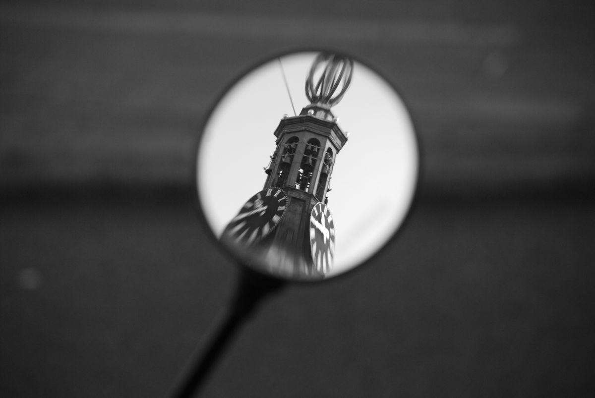 Walking along the canals in Amsterdam a couple of years ago I caught the reflection of Westerkerk  in the wing mirror of a parked scooter. This photo is the result.