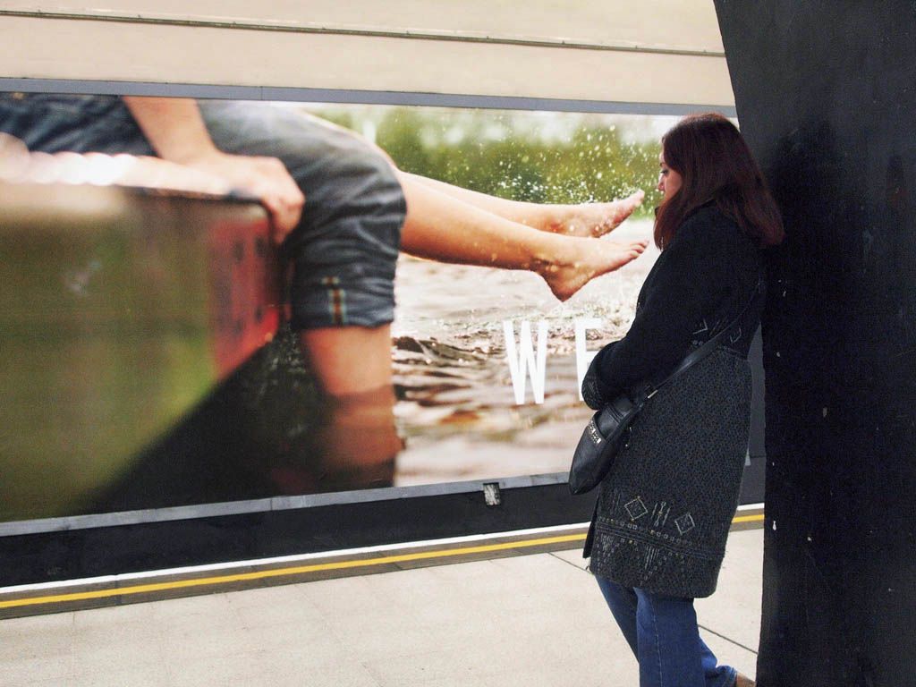 A young LAdy Blends into the background on the London Tube.