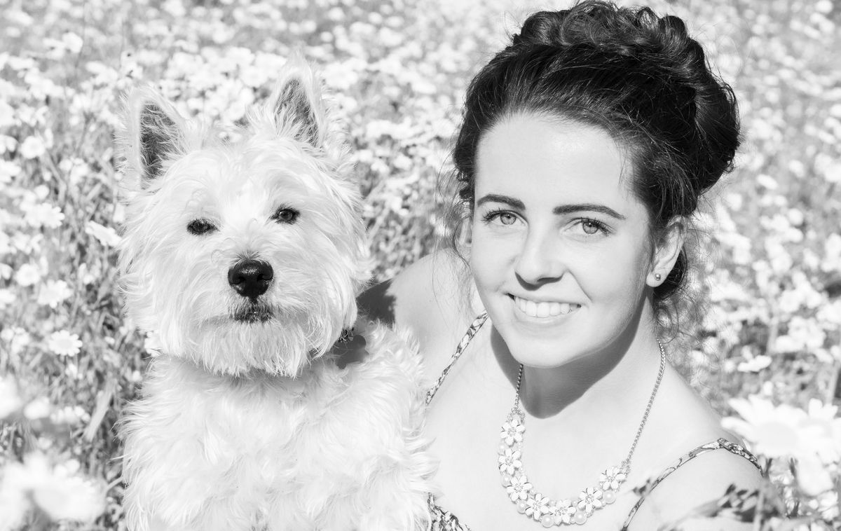 My daughter sat in a meadow with Max, a West Highland Terrier.